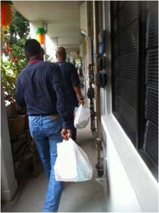 CNB officers on the way to distribute goodie bags