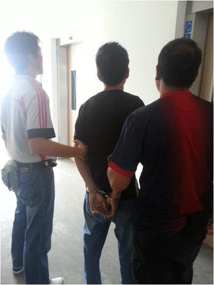 Suspect being arrested by CNB officers in operation 4-6 March 2013