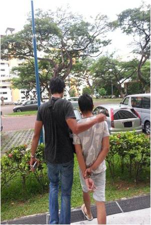 A CNB officer arresting a suspect during one operation