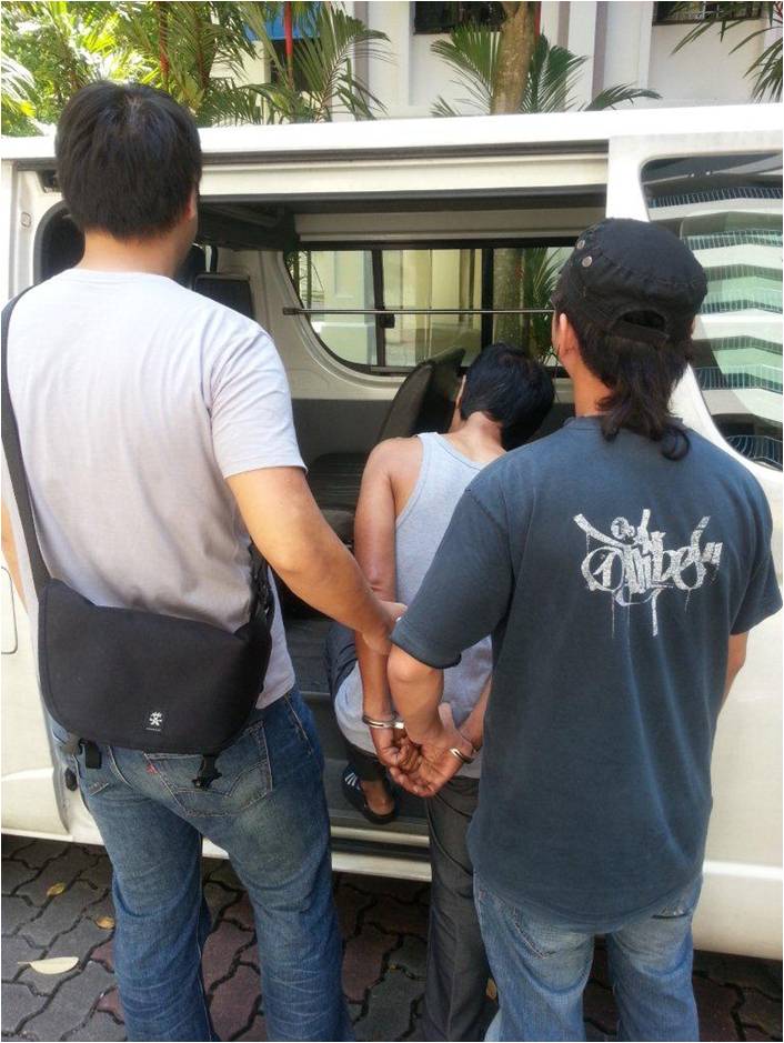 Photo 4: CNB officers arresting a drug suspect.