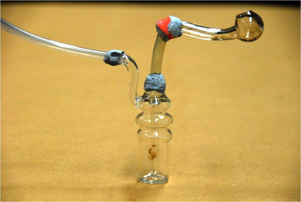 Photo 3: One of the drug-smoking apparatus seized in a CNB operation on 13 March 2014. Photo 3: One of the drug-smoking apparatus seized in a CNB operation on 13 March 2014.