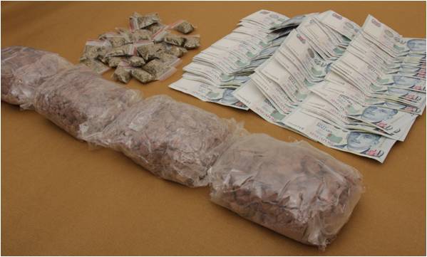 Drugs and cash seized from CNB operation on 25 June 2014.