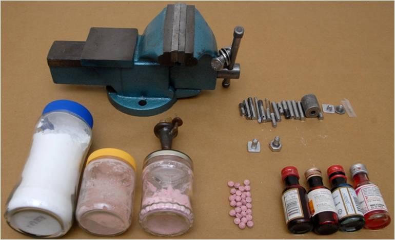 Drug exhibits seized from the suspect’s unit including the tablet press machine used to make Ecstasy tablets and adulterants used.