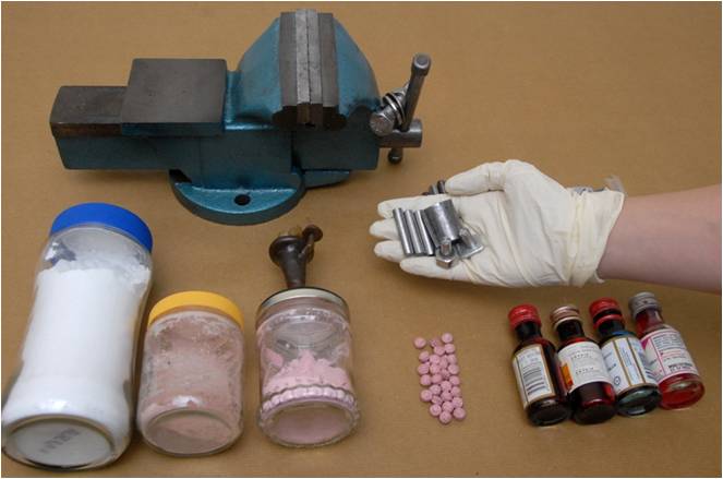 Drug exhibits seized from the suspect’s unit including the tablet press machine used to make Ecstasy tablets and adulterants used.