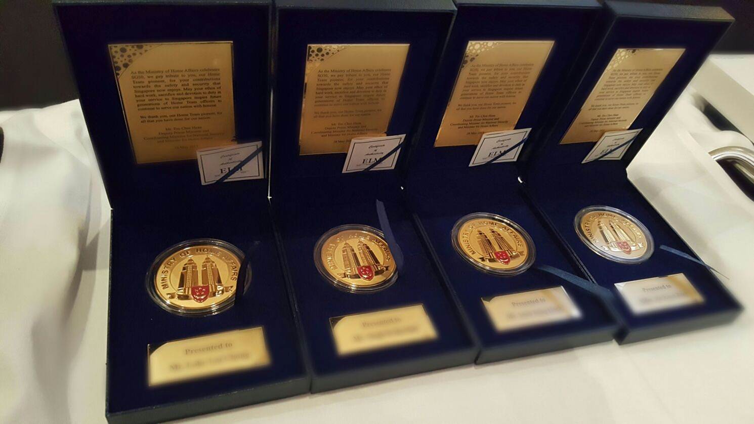Photo 2: SG50 Medallions given out to CNB pioneers during the CNB Appreciation Dinner 2015