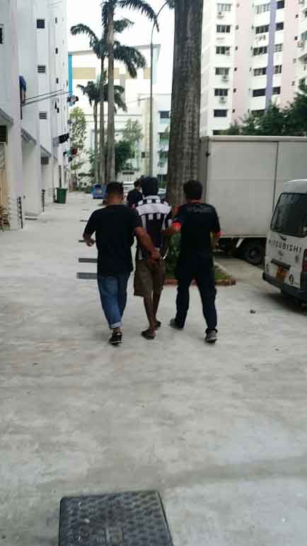 Photo-6 : CNB officers escorting a suspect arrested in CNB operation from 5-8 Oct 2015