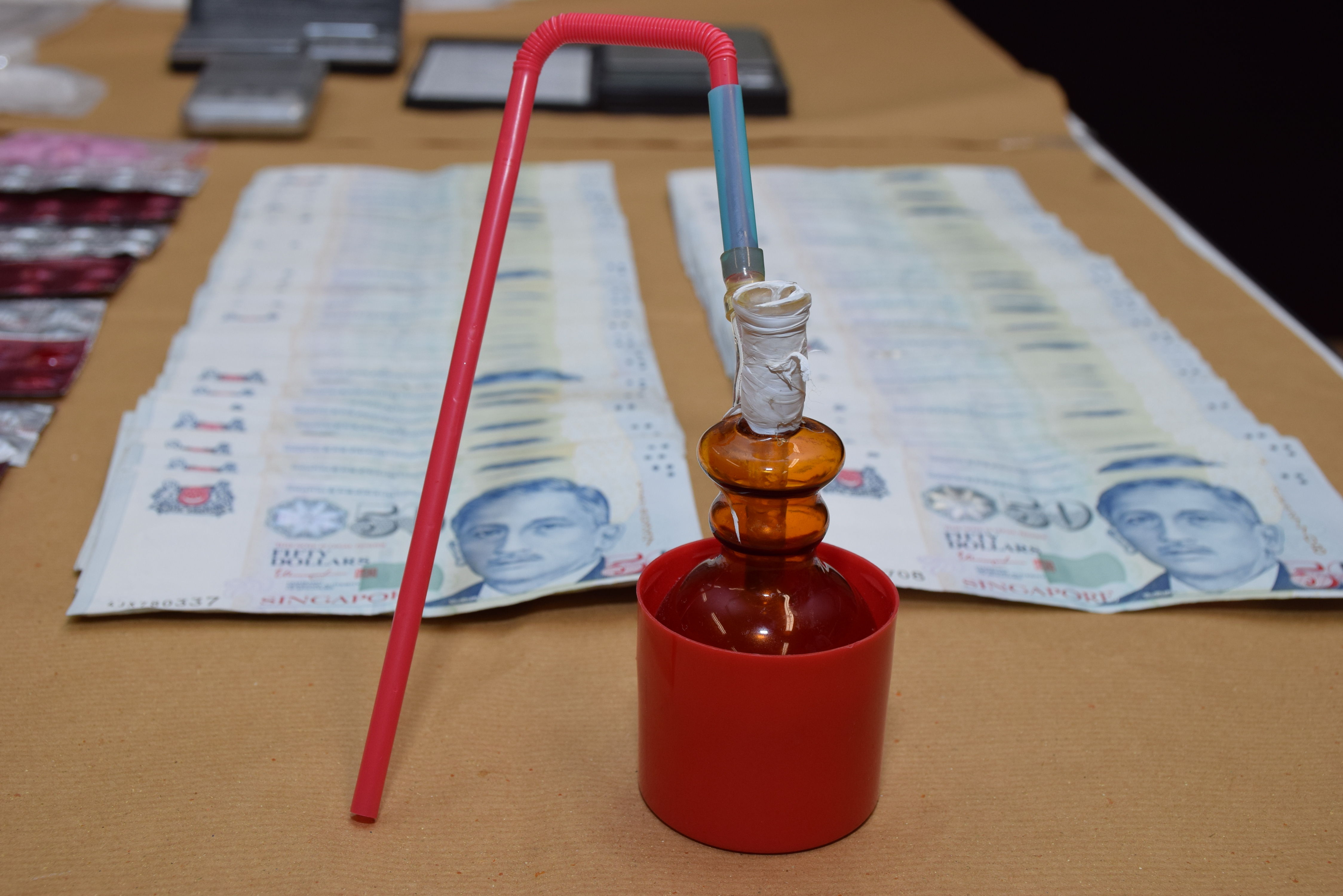 Photo 2: Drug paraphernalia and cash seized from CNB operation on 8 December 2015.