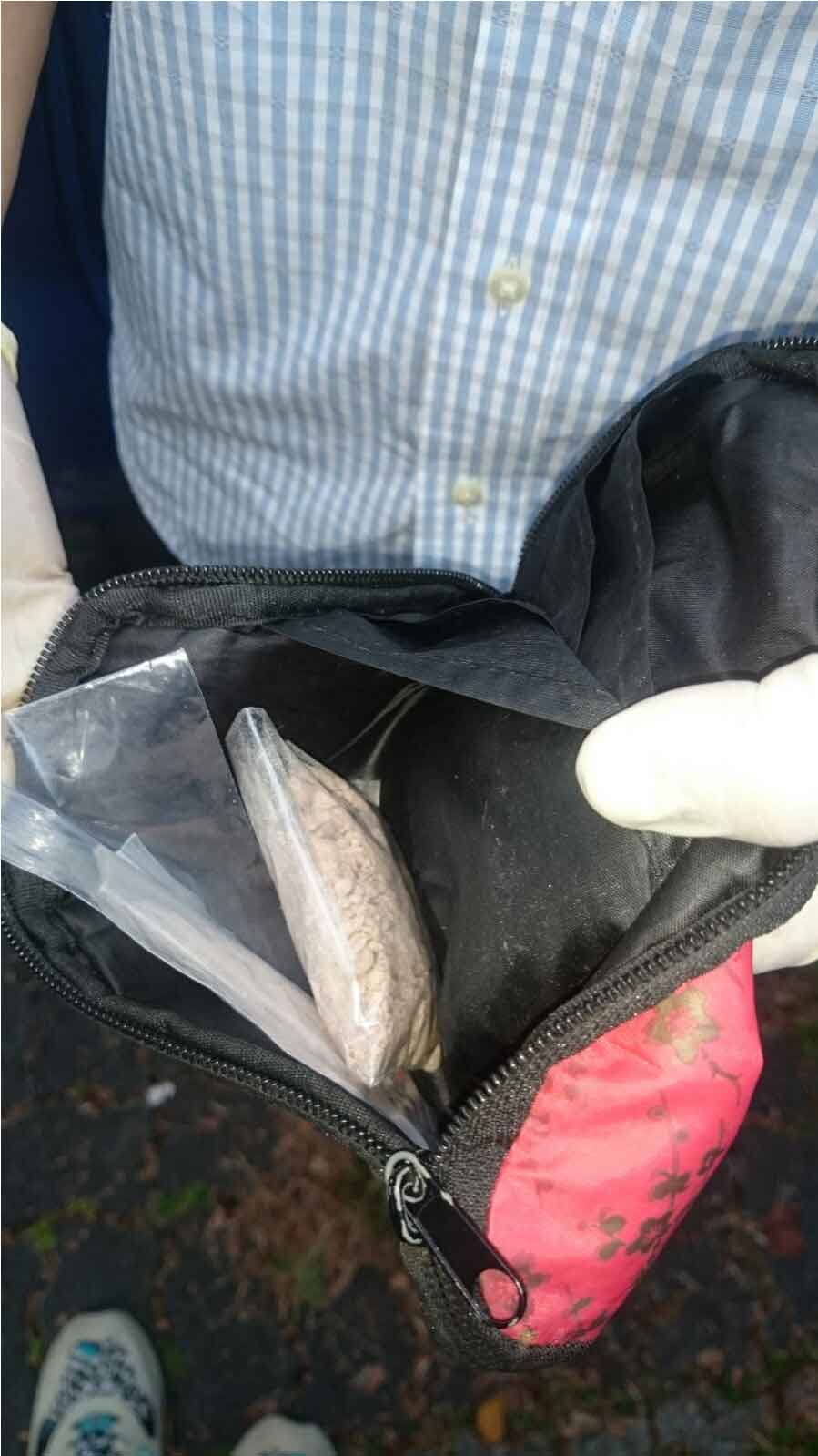 Photo-4: Heroin found in a pouch hidden in compartment behind rear seat of car