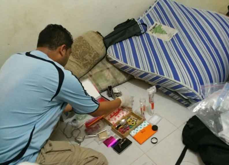 Photo-5 : CNB officer going through seized exhibits in CNB operation from 5-8 Oct 2015