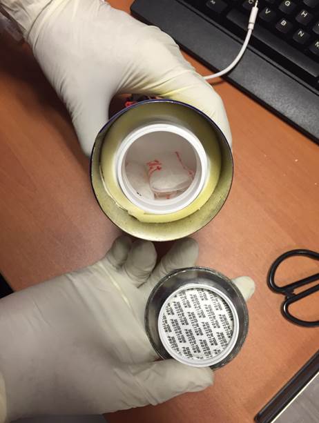 Photo-1: Closed-up view of modified interior of one of the metal cans used to conceal drugs