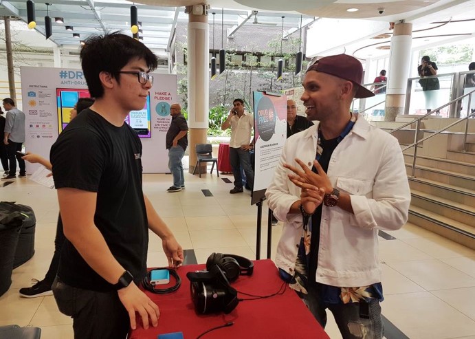Photo 3: THELIONCITYBOY at the virtual reality experience booth at CNB’s anti-drug roadshow