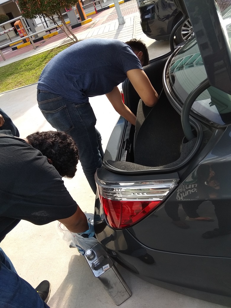 Officers conducting search of a suspect's car during 11-day island-wide operation