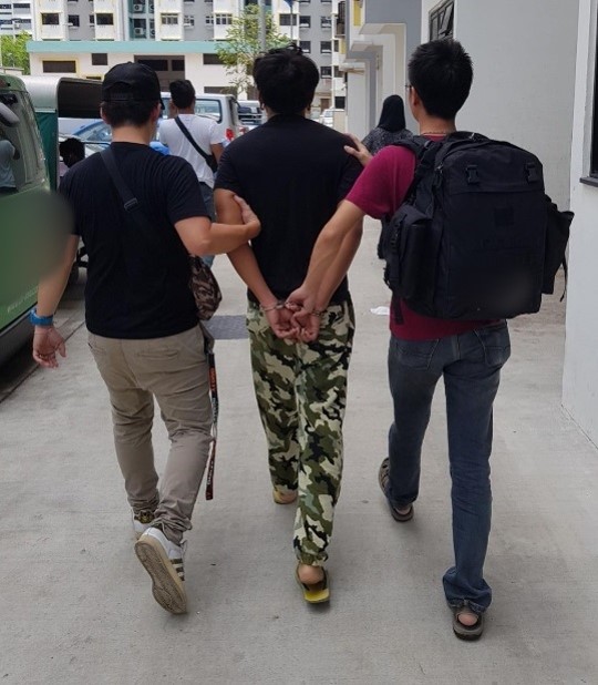 Photo-1: CNB officers escorting an arrested drug suspect, during CNB’s 4-day island-wide operation from 8 to 12 January 2018.