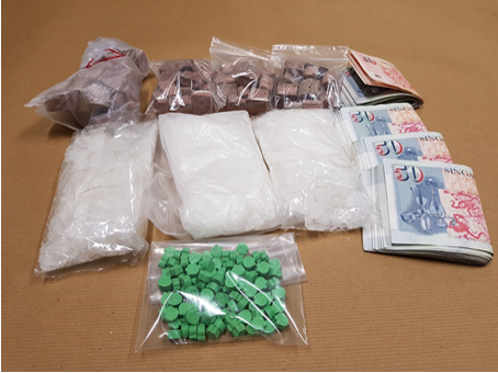 Photo-4 (CNB): Heroin, ‘Ice’ and ‘Ecstasy’ tablets and cash seized in CNB operation on 12 February 2018.