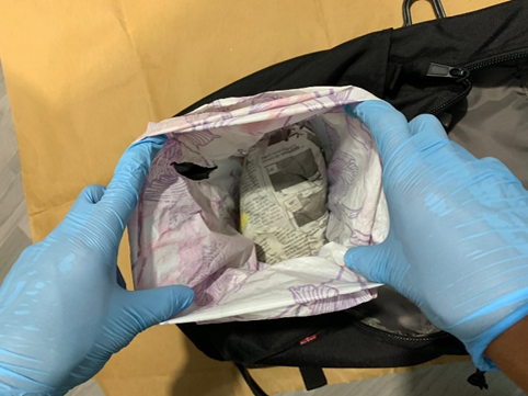 Photo-2 (CNB): Heroin found hidden within a black haversack hanging outside a unit, in CNB operation on 20 February 2019.