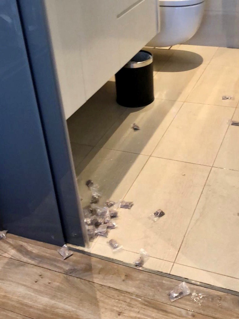 Photo 2 (CNB): Packets of heroin strewn on floor in one of the hotel rooms located in the vicinity of Beach Road, in a CNB raid on 24 September 2020