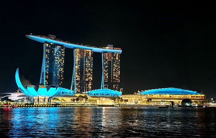 Photos 1 and 2 (CNB): Iconic buildings in the Marina Bay area illuminated in the colours of the green and white Anti-Drug Ribbon on 26 June 2019.