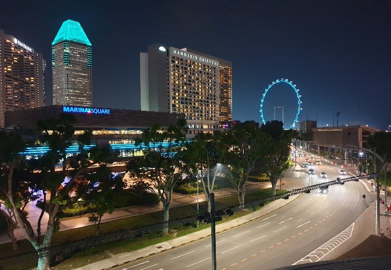 Photos 1 and 2 (CNB): Iconic buildings in the Marina Bay area illuminated in the colours of the green and white Anti-Drug Ribbon on 26 June 2019.