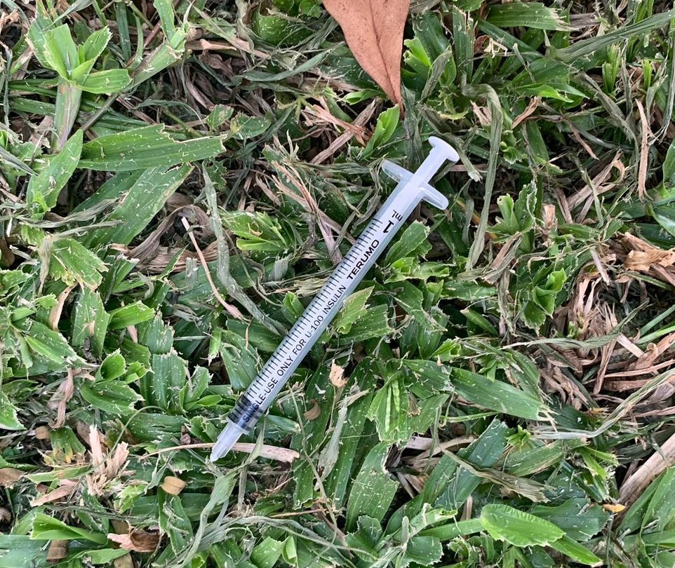 Photo-2 & Photo-3 (CNB): Syringes found on grass patch, in CNB raid on a unit at Fajar Road on 11 September 2019.