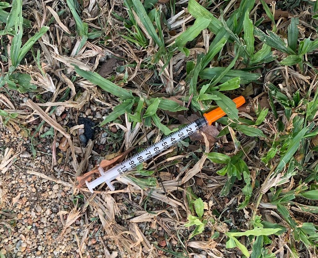 Photo-2 & Photo-3 (CNB): Syringes found on grass patch, in CNB raid on a unit at Fajar Road on 11 September 2019.