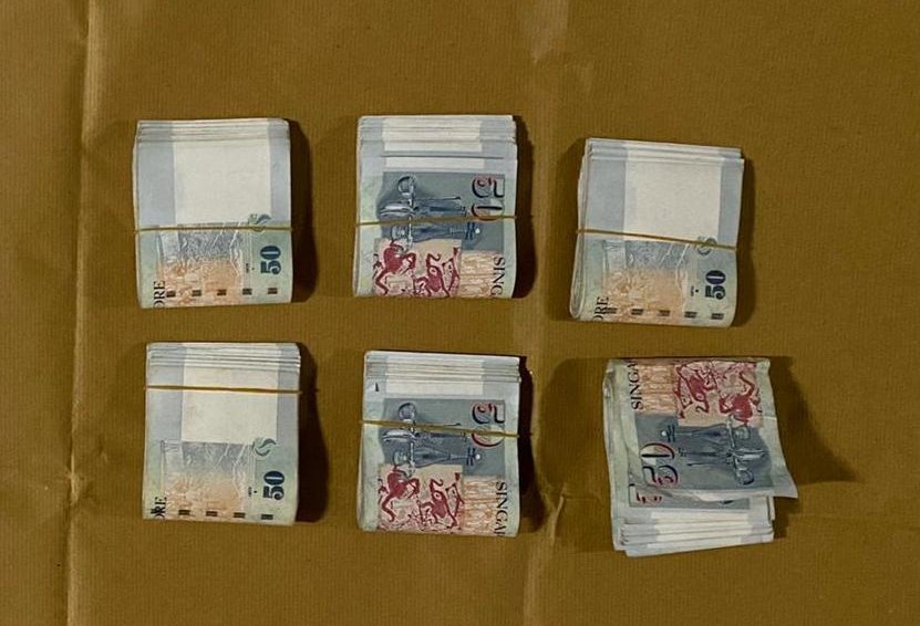 Photo-2 (CNB): Cash found on Malaysian male suspect arrested in CNB operation on 25 February 2020